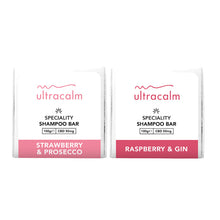 Load image into Gallery viewer, Two white packages of Ultracalm 50mg CBD Shampoo Bars. The package on the left is labeled "Strawberry & Prosecco" with a pink band at the bottom, and the one on the right is labeled "Raspberry & Gin" with a red band at the bottom. Each bar, infused with natural essential oils, contains 50mg of CBD and weighs 100g.