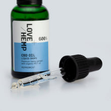 Load image into Gallery viewer, A blue and green bottle labeled "Love Hemp 600mg Peppermint CBD Oil - 30ml, Premium hemp extract with organic MCT oil" is shown. The label indicates a peppermint flavor and 600 mg strength. A dropper cap is placed next to the bottle, with droplets of CBD oil visible inside the dropper.