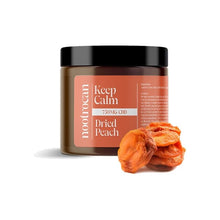 Load image into Gallery viewer, A jar labeled "Nootrocan 750mg Full Spectrum CBD Nootropic Dried Fruits - 300g" with a black lid. The jar is predominantly brown with orange accents. In front of the jar, a few dried peach slices are placed on the surface, adding a natural, vegan-friendly touch to the product display.